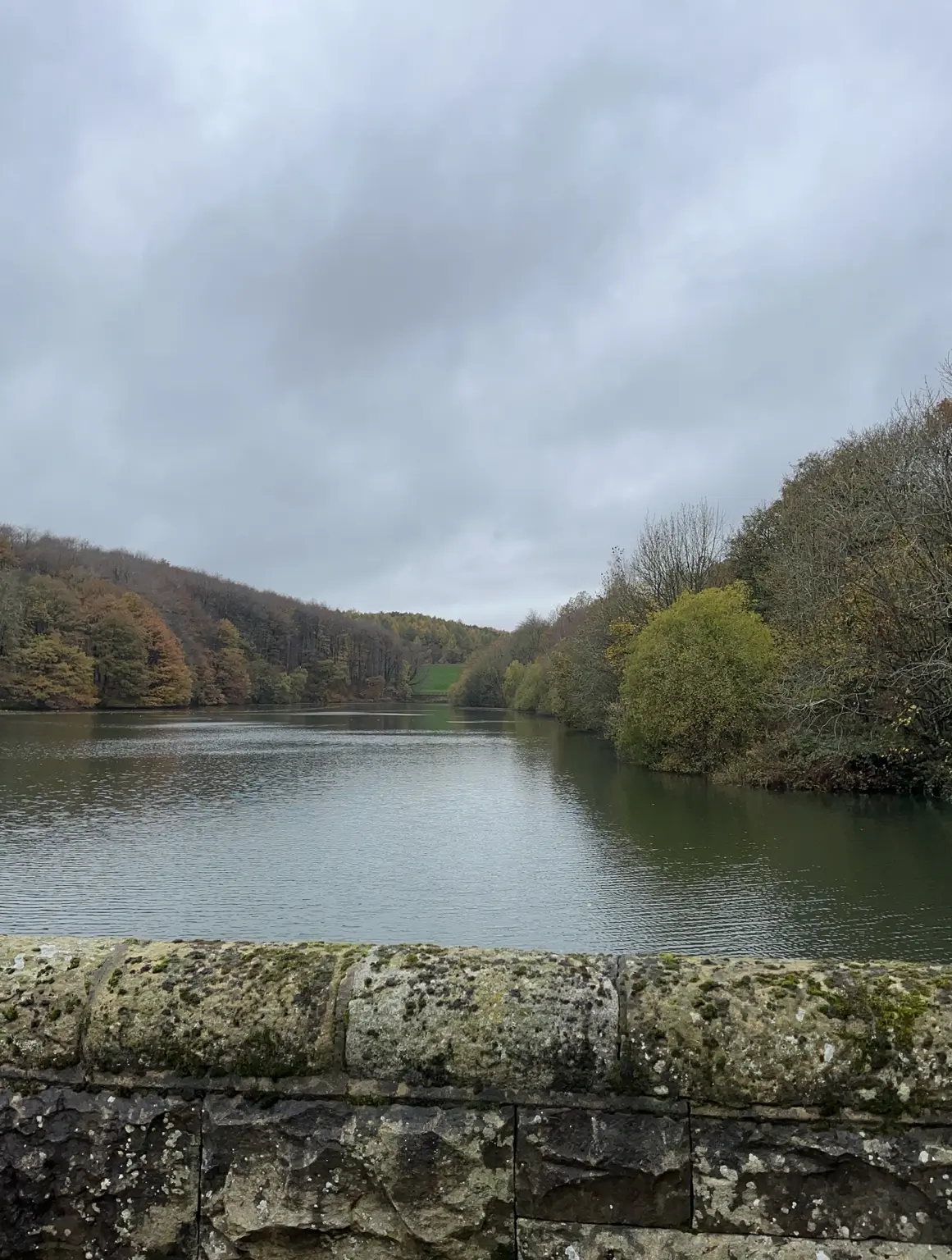 Autumn water seen above an old stone wall