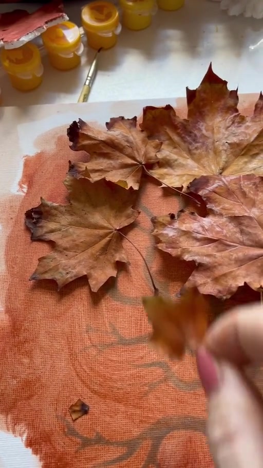 Gathered leaves arranged over a copper-coloured painted tree